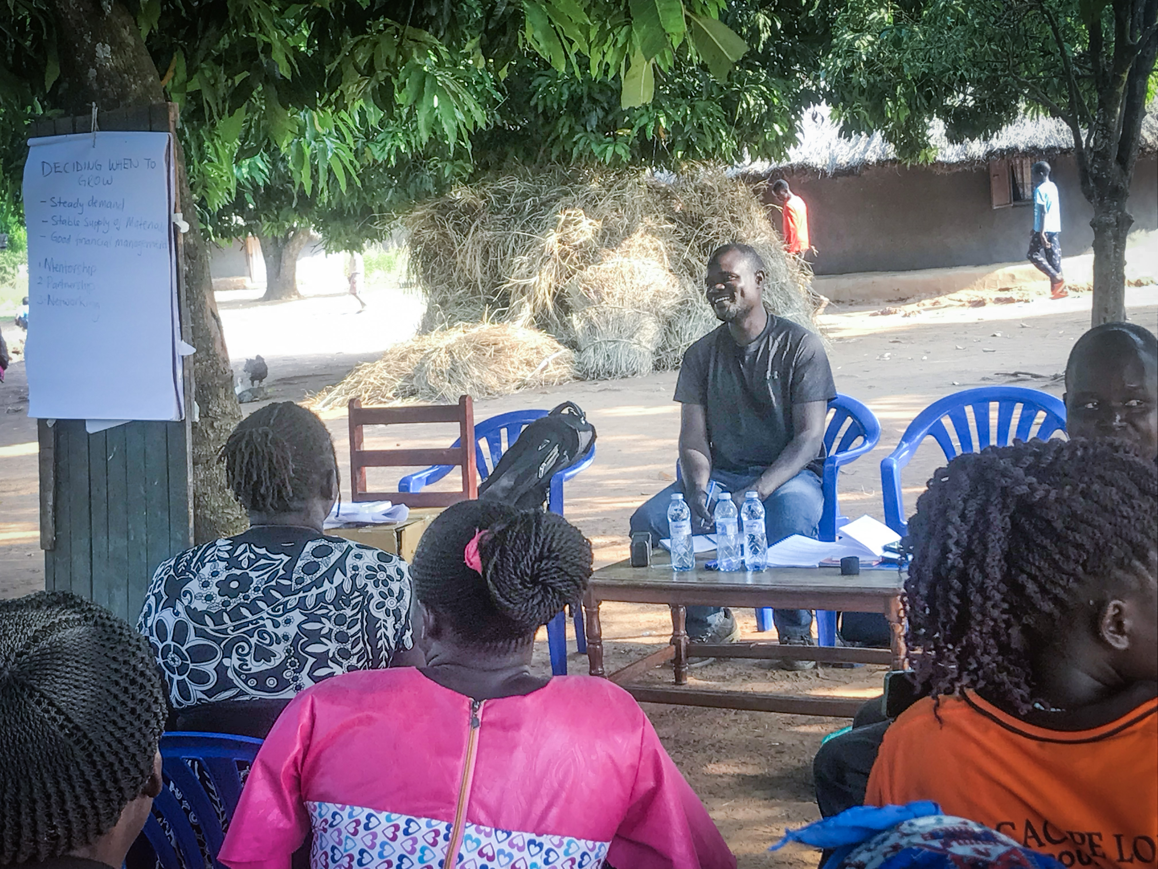 Francis Kumakech engaging with community members in Gulu
